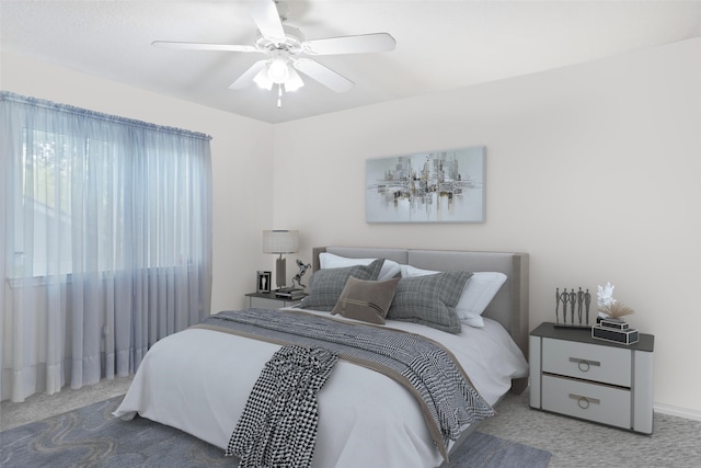 bedroom featuring ceiling fan and carpet