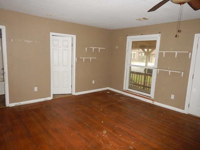 unfurnished room featuring ceiling fan and dark wood-type flooring