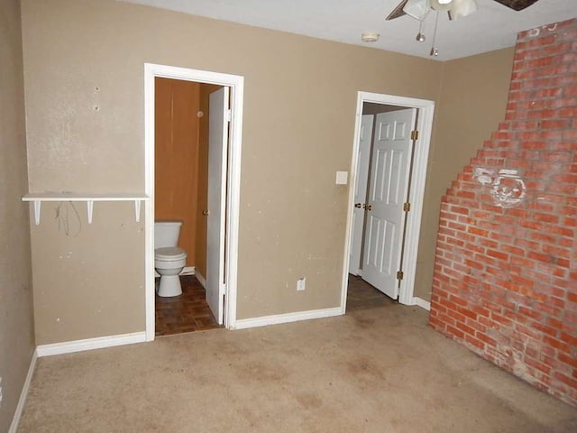 unfurnished bedroom featuring connected bathroom, ceiling fan, and light carpet