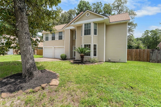 view of front of property with a garage and a front lawn