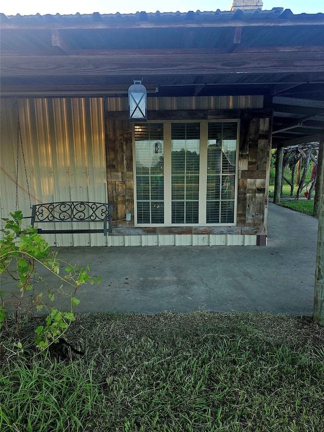 doorway to property featuring a mountain view and a patio area