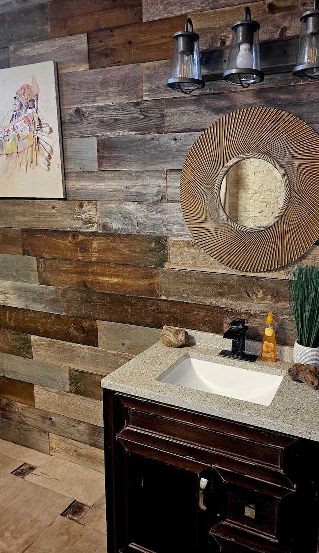 bathroom featuring vanity and wood walls