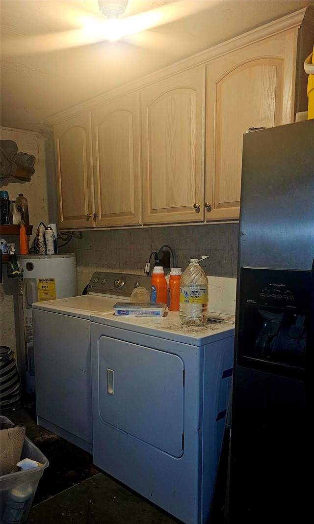 laundry area featuring cabinets, electric water heater, and washing machine and dryer