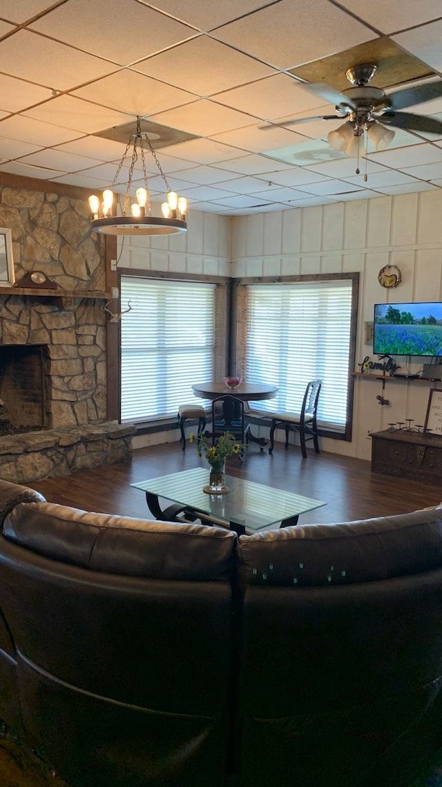 living room featuring a paneled ceiling, a fireplace, and ceiling fan