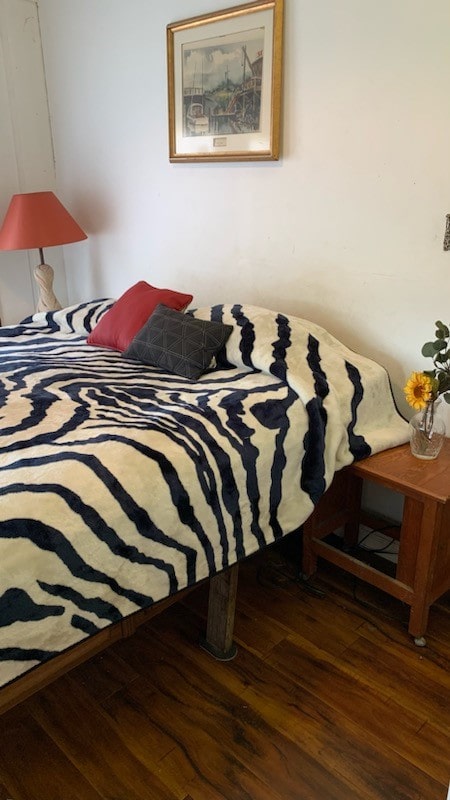 bedroom with dark hardwood / wood-style flooring