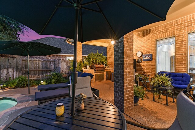 view of patio / terrace with exterior kitchen and a grill