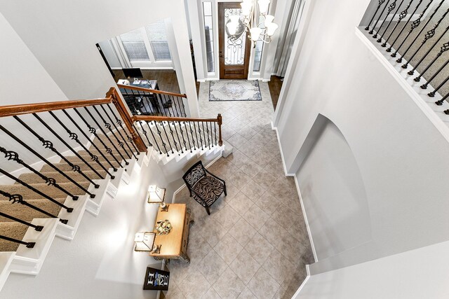 tiled foyer with an inviting chandelier