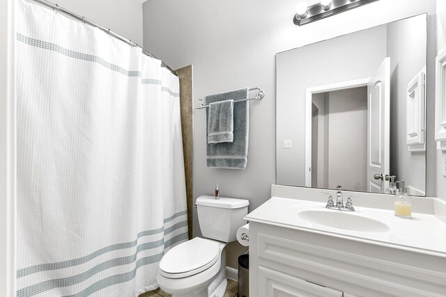 bathroom with vanity, tile patterned flooring, and toilet