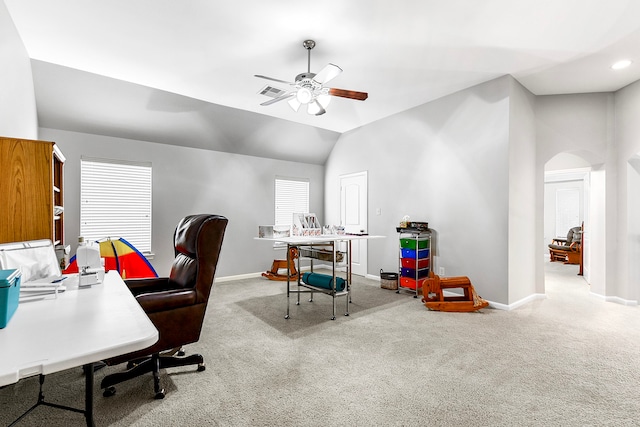 carpeted office space with lofted ceiling and ceiling fan