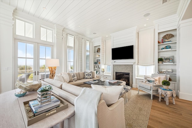 living room featuring hardwood / wood-style floors, built in features, french doors, and wooden ceiling