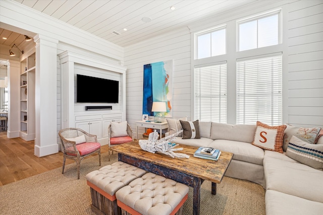 living room featuring wood-type flooring, wooden walls, and wood ceiling