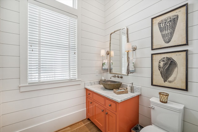 bathroom with vanity, hardwood / wood-style flooring, toilet, and plenty of natural light