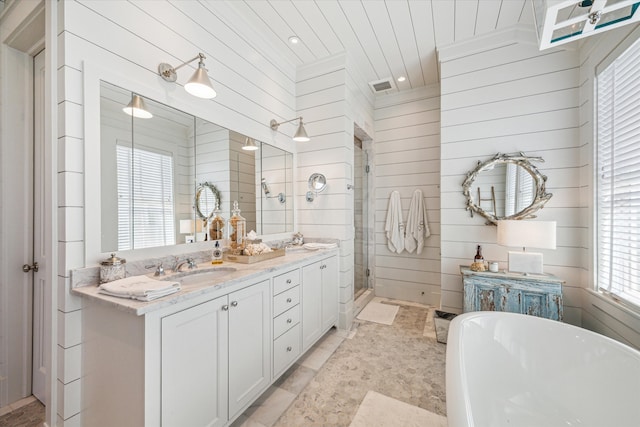 bathroom with wooden walls, vanity, and shower with separate bathtub