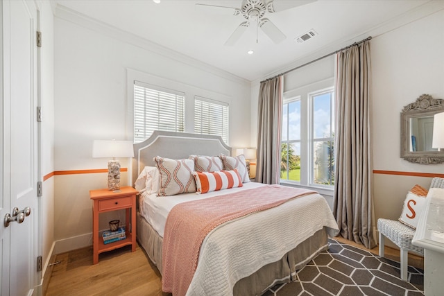 bedroom featuring ceiling fan, hardwood / wood-style floors, and ornamental molding