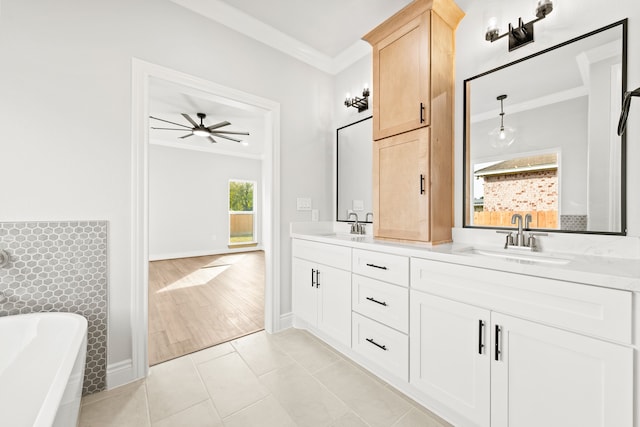 bathroom featuring vanity, wood-type flooring, ceiling fan, ornamental molding, and a tub