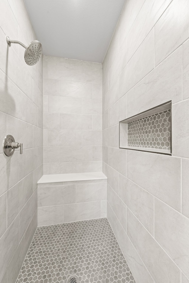 bathroom with a tile shower