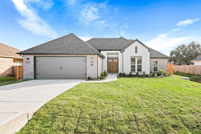 view of front of property featuring a garage and a front yard