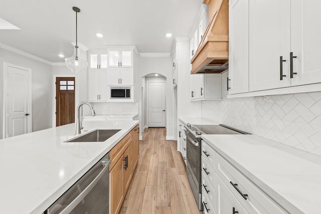 kitchen with appliances with stainless steel finishes, white cabinetry, and sink