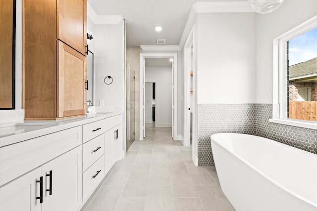 bathroom featuring shower with separate bathtub, tile patterned flooring, vanity, and crown molding