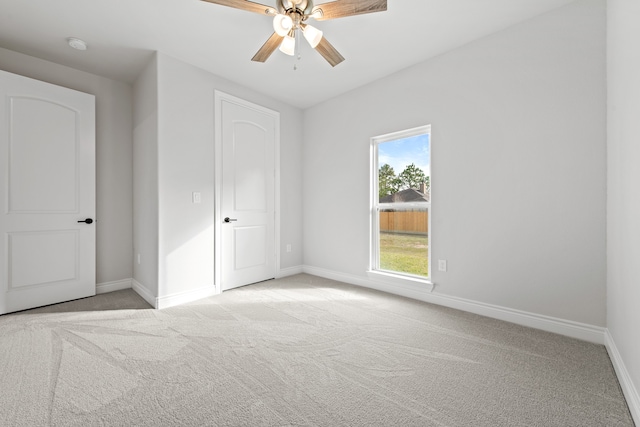 unfurnished bedroom with ceiling fan and light carpet