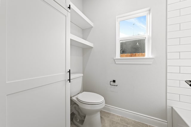 bathroom with tile patterned flooring and toilet