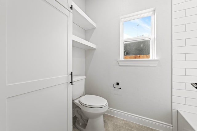 15408 Sandtrap Dr, Waller, TX 77484 - bathroom with baseboards, toilet, tile patterned floors, and a bath