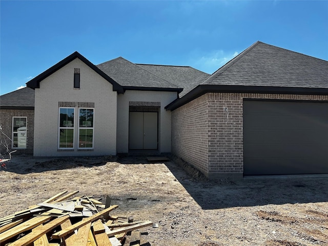 15408 Sandtrap Dr, Waller, TX 77484 - view of front of house featuring roof with shingles, brick siding, and a garage