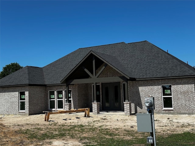 15408 Sandtrap Dr, Waller, TX 77484 - view of front of property featuring brick siding, a shingled roof, and french doors