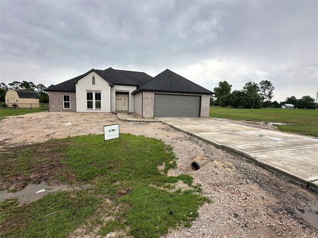 15408 Sandtrap Dr, Waller, TX 77484 - view of front of property featuring a garage, driveway, a front yard, roof with shingles, and brick siding