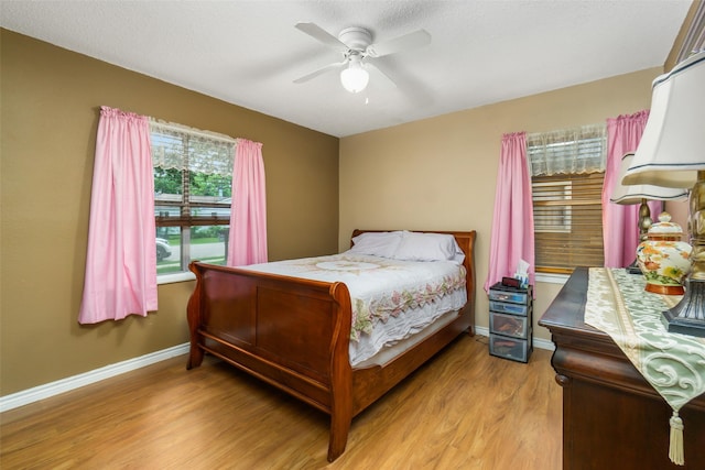 bedroom with light hardwood / wood-style floors and ceiling fan