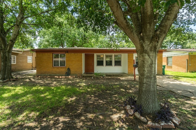 ranch-style house featuring entry steps and brick siding