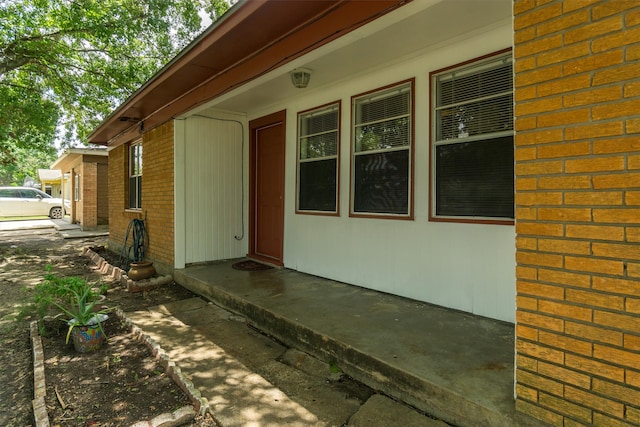 view of side of home with brick siding