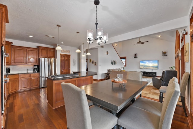 dining room featuring ceiling fan, dark hardwood / wood-style flooring, and a textured ceiling