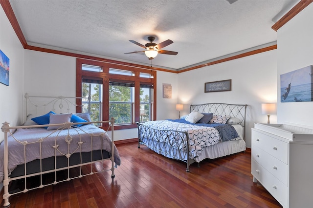 bedroom featuring crown molding, ceiling fan, dark hardwood / wood-style floors, and a textured ceiling