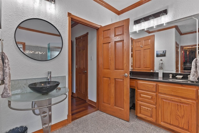 bathroom with crown molding and vanity