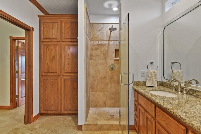 bathroom with walk in shower, ornamental molding, and vanity