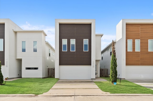 contemporary house with a front yard and a garage