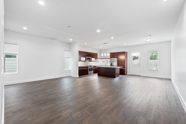 unfurnished living room featuring dark hardwood / wood-style flooring and sink