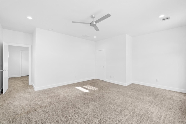 carpeted spare room with ceiling fan