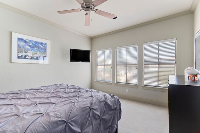 bedroom with ceiling fan, carpet floors, and crown molding