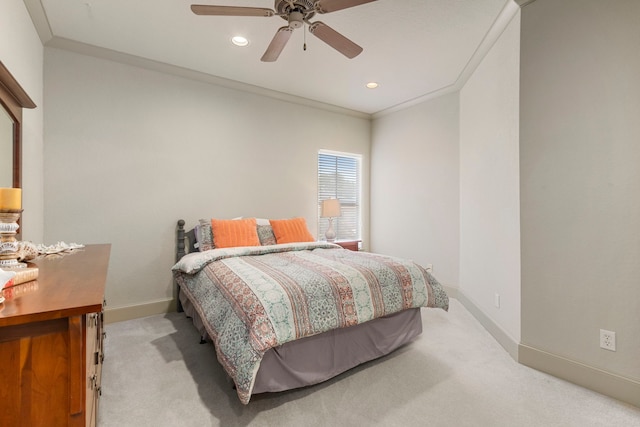 bedroom featuring ornamental molding, ceiling fan, and light carpet