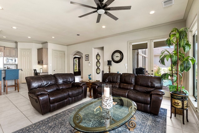 living room with ceiling fan, light tile patterned floors, and crown molding