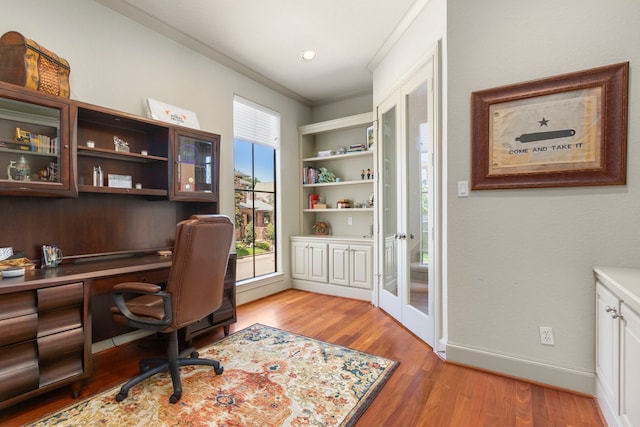 home office with hardwood / wood-style flooring and ornamental molding