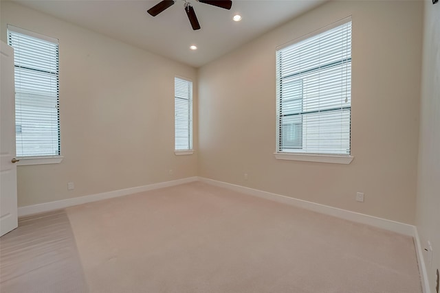 unfurnished room with ceiling fan and light colored carpet