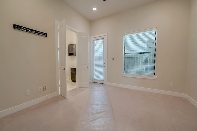 doorway to outside featuring light colored carpet