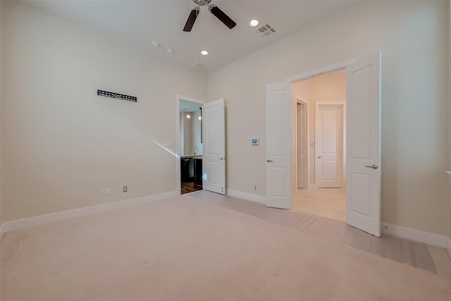 unfurnished bedroom with light carpet and ceiling fan