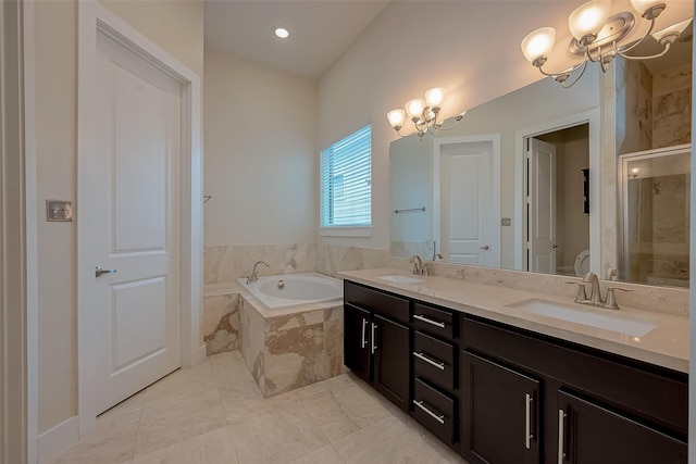 bathroom with vanity, an inviting chandelier, and independent shower and bath