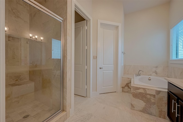 bathroom with vanity and separate shower and tub