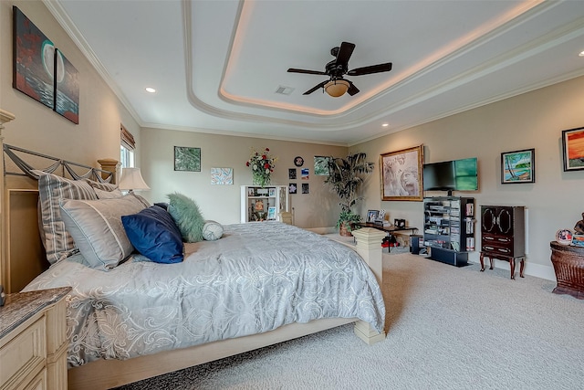 bedroom featuring crown molding, carpet floors, ceiling fan, and a tray ceiling