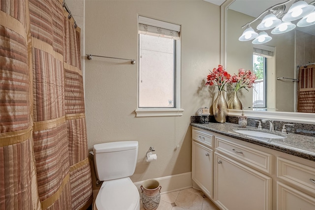 bathroom featuring tile patterned flooring, vanity, and toilet